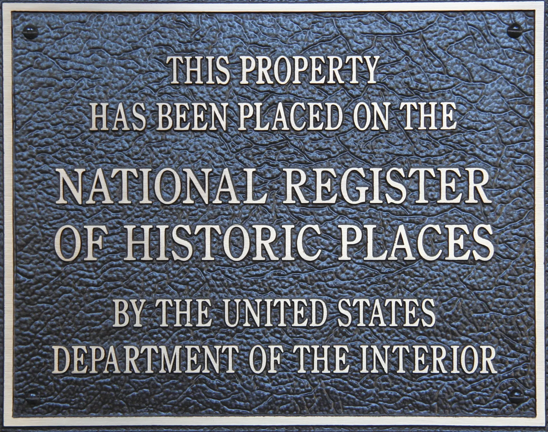 Plaque declaring "this property has been placed on the National Register of Historic Places by the United States Department of the Interior"